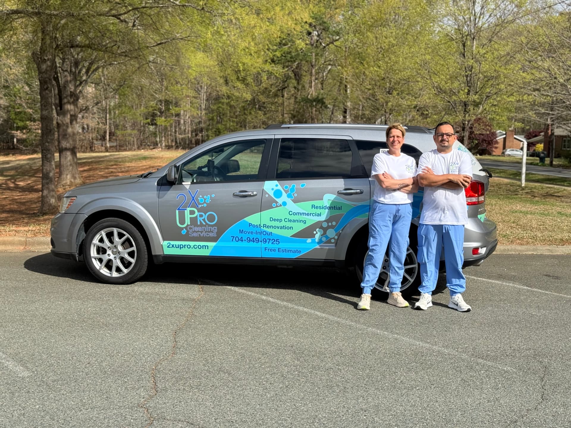 Claudia and Bruno standing beside the branded 2XUPro Cleaning Services vehicle