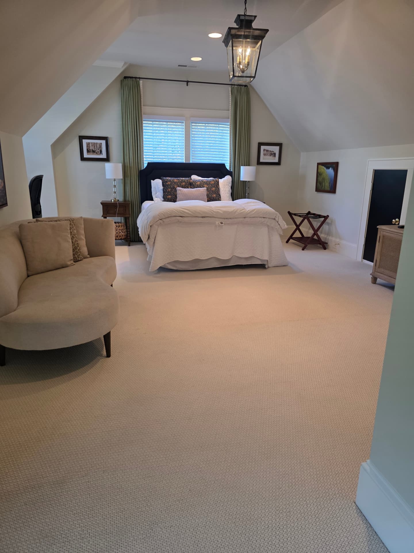 Bedroom with a neatly made bed and vacuumed carpet after a cleaning visit